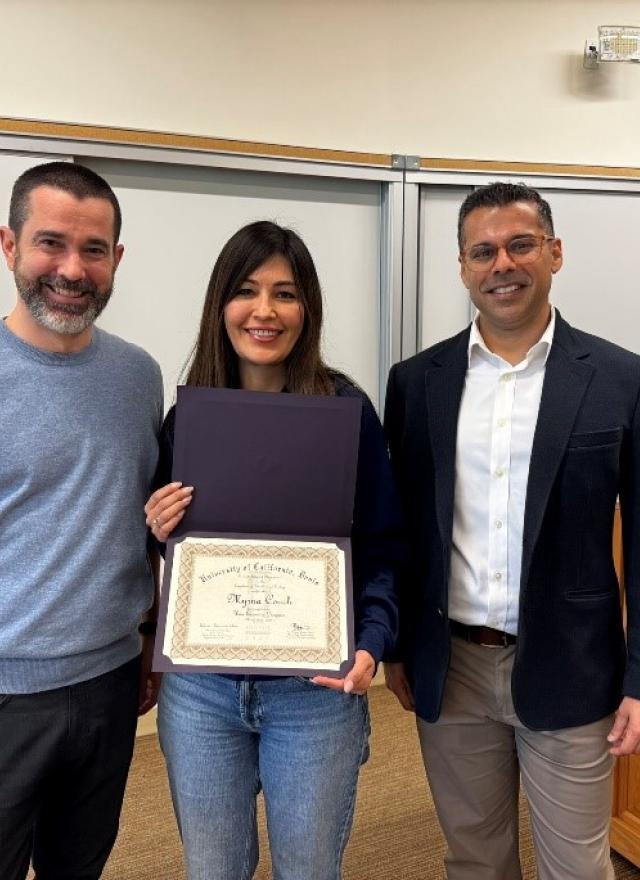 Myrna Robles Couch holding up a certificate with Ben Montpetit and Ashwin Aravindakshan