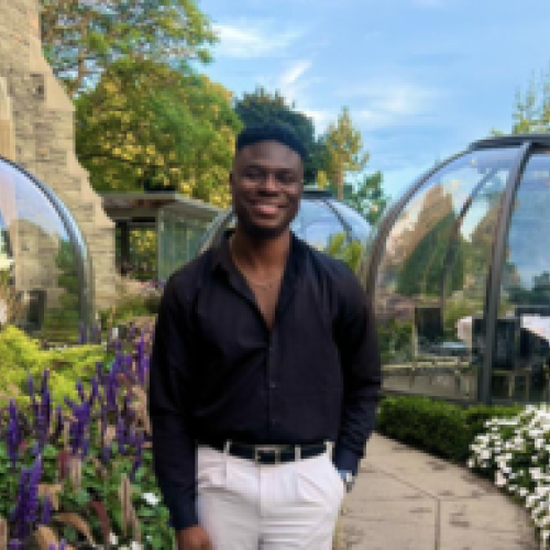 Lanre Akinfemiwa standing in a garden