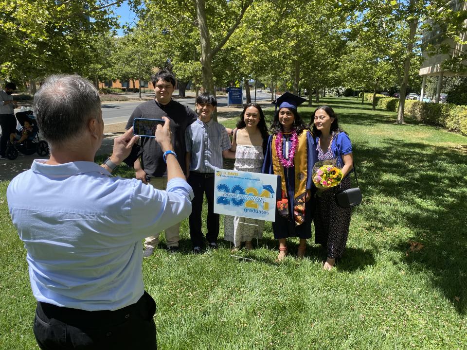 Jessica Padolina and family take a photo at Aggie Grad Walk