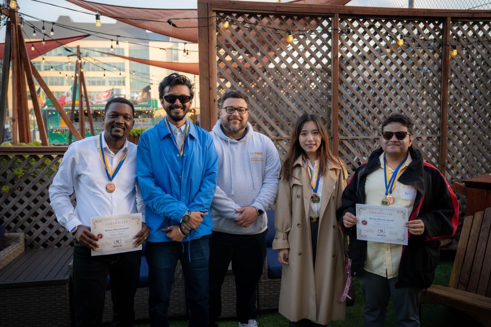 MSBA students holding up certificates