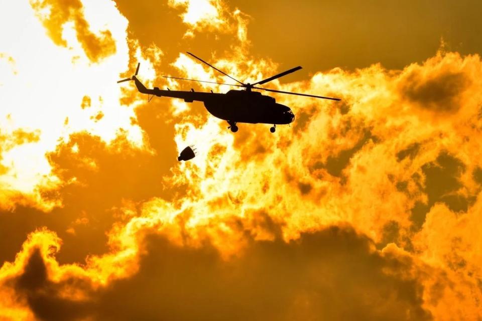 Helicopter over fire sky