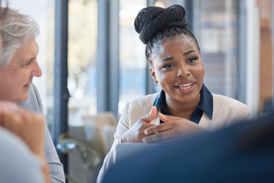 stock photo of a woman leading a work meeting