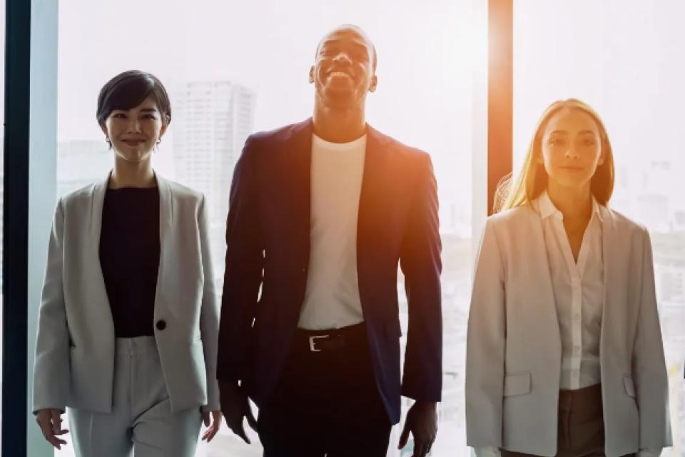 a trio of diverse professionals in an office setting